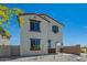 Two-story home with white exterior, accented by brown trim, green door, and minimalist landscaping at 15622 S 181St Dr, Goodyear, AZ 85338