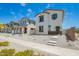 Two-story home with white exterior, brown trim, a green door, minimal landscaping, and a concrete walkway at 15622 S 181St Dr, Goodyear, AZ 85338