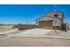 Beautiful home exterior featuring a large garage, manicured landscaping, and a long driveway at 15622 S 181St Dr, Goodyear, AZ 85338