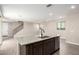 Open floor plan with island bar, granite countertops, stainless dishwasher, modern flooring, and stairs at 15622 S 181St Dr, Goodyear, AZ 85338