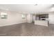 Open-concept living space with modern wood-look tile floors and neutral walls, leading into a well-equipped kitchen at 15622 S 181St Dr, Goodyear, AZ 85338