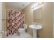 Bathroom featuring shower with patterned curtain, toilet and pedestal sink at 1668 E Melissa St, Casa Grande, AZ 85122