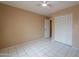 Bedroom featuring tile flooring, ceiling fan, neutral paint and closet at 1668 E Melissa St, Casa Grande, AZ 85122