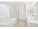 Bright bathroom with a double vanity, separate shower, soaking tub and tile floors at 17012 S 27Th Ln, Phoenix, AZ 85045