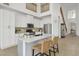 Bright kitchen with white cabinets, stainless steel appliances, large island, and bar stool seating at 17012 S 27Th Ln, Phoenix, AZ 85045