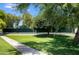 Well-maintained tennis court with green surroundings, offering a great space for sports and outdoor activities at 2425 E Oregon Ave, Phoenix, AZ 85016