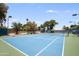Outdoor tennis court with blue hard surface, green accents and enclosed fencing, perfect for recreational play at 2425 E Oregon Ave, Phoenix, AZ 85016
