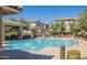 Community pool offers lounge chairs and a covered area with community building and views of surrounding homes at 272 N Wilson Dr, Chandler, AZ 85225