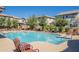 Beautiful community pool surrounded by lounge chairs and manicured landscaping with views of nearby houses at 272 N Wilson Dr, Chandler, AZ 85225