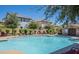Inviting community pool featuring lounge chairs and lush landscaping with nearby residential buildings at 272 N Wilson Dr, Chandler, AZ 85225