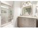 Updated bathroom features a granite vanity and a stylish glass-enclosed shower with tile accents at 3269 E San Remo Ave, Gilbert, AZ 85234