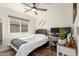 Cozy bedroom featuring a ceiling fan, natural light, and a functional desk area with dual monitors at 3269 E San Remo Ave, Gilbert, AZ 85234