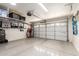 Spacious garage with epoxy flooring and ample overhead storage shelves for efficient organization and cleanliness at 3269 E San Remo Ave, Gilbert, AZ 85234