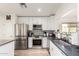 Modern kitchen boasts stainless steel appliances, white cabinetry, stylish backsplash, and great lighting at 3269 E San Remo Ave, Gilbert, AZ 85234