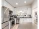 Contemporary kitchen with stainless steel appliances, white cabinets, tile backsplash, and functional island at 3269 E San Remo Ave, Gilbert, AZ 85234
