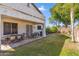 The backyard features a large covered patio, lush lawn and mature landscaping at 6409 N 11Th Dr, Phoenix, AZ 85013