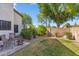 The backyard features a stone firepit, mature landscaping, and a lawn at 6409 N 11Th Dr, Phoenix, AZ 85013