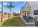 The backyard has a covered patio area, spacious grassy area, and tasteful landscaping at 6409 N 11Th Dr, Phoenix, AZ 85013
