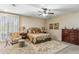 Cozy bedroom with ceiling fan, carpet, and natural light from the window at 6409 N 11Th Dr, Phoenix, AZ 85013