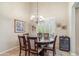 Elegant dining room featuring a round table with seating for six, complemented by a stylish chandelier and wine cooler at 6409 N 11Th Dr, Phoenix, AZ 85013