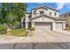 Charming two-story home featuring a three-car garage and well-manicured lawn, creating an inviting curb appeal at 6409 N 11Th Dr, Phoenix, AZ 85013