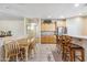 Open kitchen and dining area with breakfast bar and tile flooring throughout at 6409 N 11Th Dr, Phoenix, AZ 85013