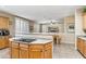 Kitchen with breakfast bar and view of the living and dining areas at 6409 N 11Th Dr, Phoenix, AZ 85013