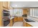 Well-equipped kitchen with stainless steel appliances, double ovens, and center island at 6409 N 11Th Dr, Phoenix, AZ 85013
