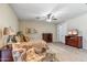 Spacious main bedroom with a ceiling fan, dresser, TV and cozy chair at 6409 N 11Th Dr, Phoenix, AZ 85013