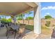 Covered patio offers an ideal space for outdoor dining and entertaining with views of the landscaped backyard at 6409 N 11Th Dr, Phoenix, AZ 85013