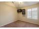 A small bedroom with neutral paint and a window with blinds at 1024 N Ithica Ct, Chandler, AZ 85225