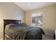 A bedroom with neutral paint, a window with blinds, and a wooden headboard at 1024 N Ithica Ct, Chandler, AZ 85225
