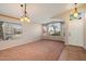 Inviting living room with large windows, neutral paint, and carpet flooring at 1024 N Ithica Ct, Chandler, AZ 85225