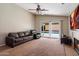 A comfortable living room with a large leather sofa and access to the outdoor pool area through sliding glass doors at 1024 N Ithica Ct, Chandler, AZ 85225