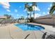 Backyard pool with tanning deck and palm trees, perfect for hot summer days at 1024 N Ithica Ct, Chandler, AZ 85225
