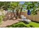 Private backyard oasis with palm trees, lounge chair, and artificial turf for easy maintenance at 10591 E Saddlehorn Dr, Scottsdale, AZ 85258