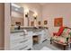 Elegant bathroom with dual vanities, decorative chairs, and stylish mirrors, for a functional space at 10591 E Saddlehorn Dr, Scottsdale, AZ 85258
