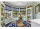 Cozy breakfast nook featuring bright light from the bay window and an adjacent bookshelf at 10591 E Saddlehorn Dr, Scottsdale, AZ 85258
