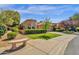 Inviting home with manicured lawn, lush landscaping, and a charming front yard bench seating area at 10591 E Saddlehorn Dr, Scottsdale, AZ 85258