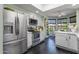 Bright kitchen featuring stainless steel appliances, a skylight, white cabinets, and an adjacent breakfast nook at 10591 E Saddlehorn Dr, Scottsdale, AZ 85258