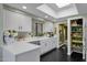 Bright kitchen with white countertops and cabinets, stainless steel sink, and a view of the garden at 10591 E Saddlehorn Dr, Scottsdale, AZ 85258