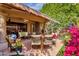 Inviting covered patio with tile flooring, lounge seating, and dining area perfect for outdoor entertaining at 10591 E Saddlehorn Dr, Scottsdale, AZ 85258