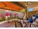Inviting outdoor patio with comfortable seating, a retractable awning, and colorful flowers at 10591 E Saddlehorn Dr, Scottsdale, AZ 85258