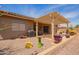 Backyard featuring covered patio, desert landscaping, and space for outdoor entertaining at 10861 E Olla Ave, Mesa, AZ 85212