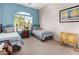 Charming bedroom showcasing serene blue walls, matching twin beds, and ample natural light at 10861 E Olla Ave, Mesa, AZ 85212