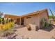 Back exterior showcasing a well-maintained home and desert landscaping, offering curb appeal at 10861 E Olla Ave, Mesa, AZ 85212