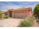 Exterior view of home with desert landscaping and a two-car garage at 10861 E Olla Ave, Mesa, AZ 85212