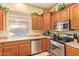 Well-equipped kitchen featuring stainless steel appliances, ample cabinet space, and a bright window for natural light at 10861 E Olla Ave, Mesa, AZ 85212