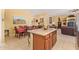 Open-concept kitchen and dining area with a large island and access to the living room, perfect for entertaining at 10861 E Olla Ave, Mesa, AZ 85212