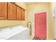 Practical laundry room featuring a washer, dryer, and cabinet storage, ideal for organization at 10861 E Olla Ave, Mesa, AZ 85212